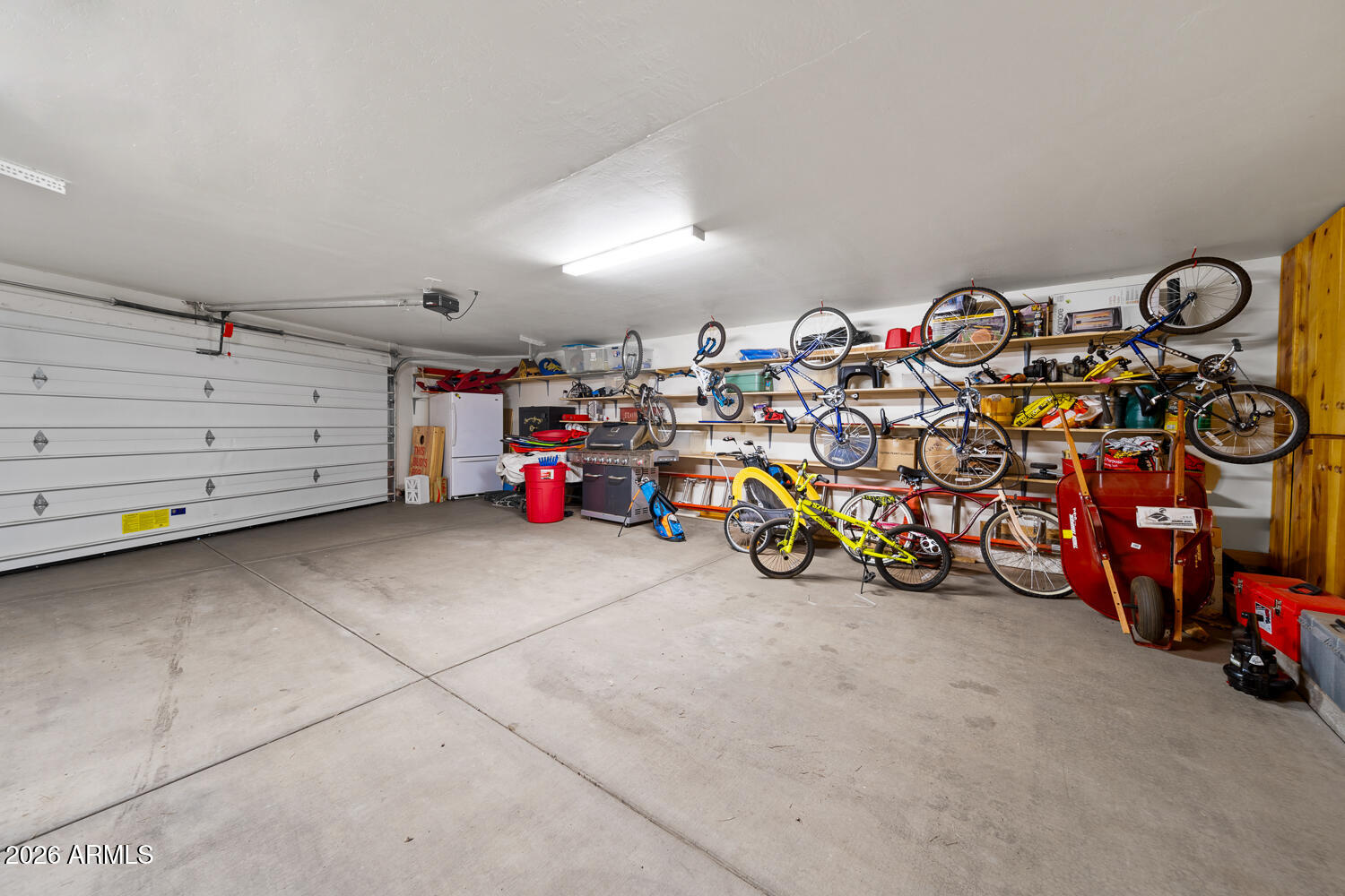 2539 Butterfly Lane Pinetop, AZ 85935 - Photo 59 of 61 a view of a garage with a bike and white walls