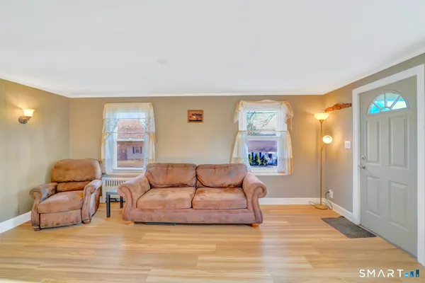 a bedroom with a bed and a large window with outer view