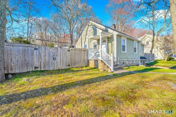 a view of a house with backyard and porch