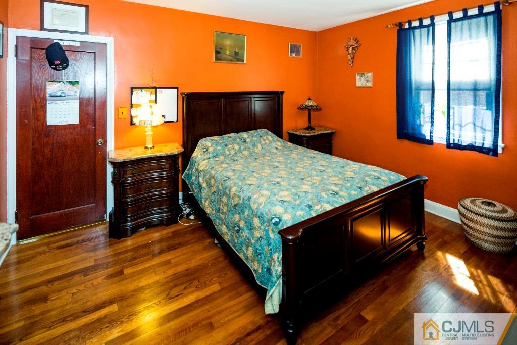 27 Old Post Road Edison, NJ 08817 - Photo 11 of 25 a bedroom with a bed and a tv on dresser
