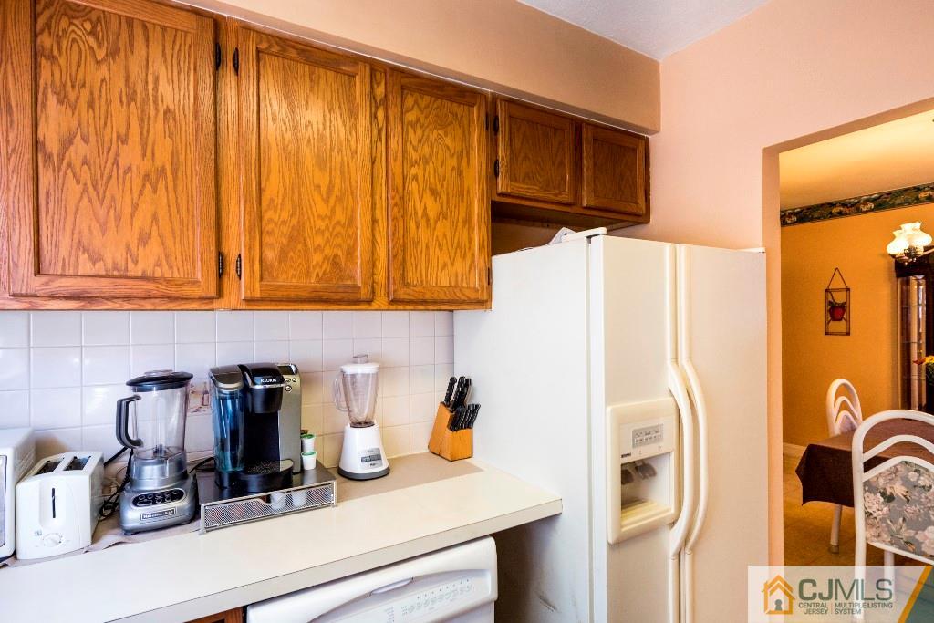 27 Old Post Road Edison, NJ 08817 - Photo 9 of 25 a kitchen with a refrigerator and cabinets