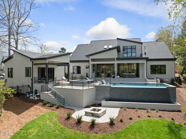 a view of a house with swimming pool and sitting area
