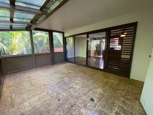a view of a room with wooden floor and windows