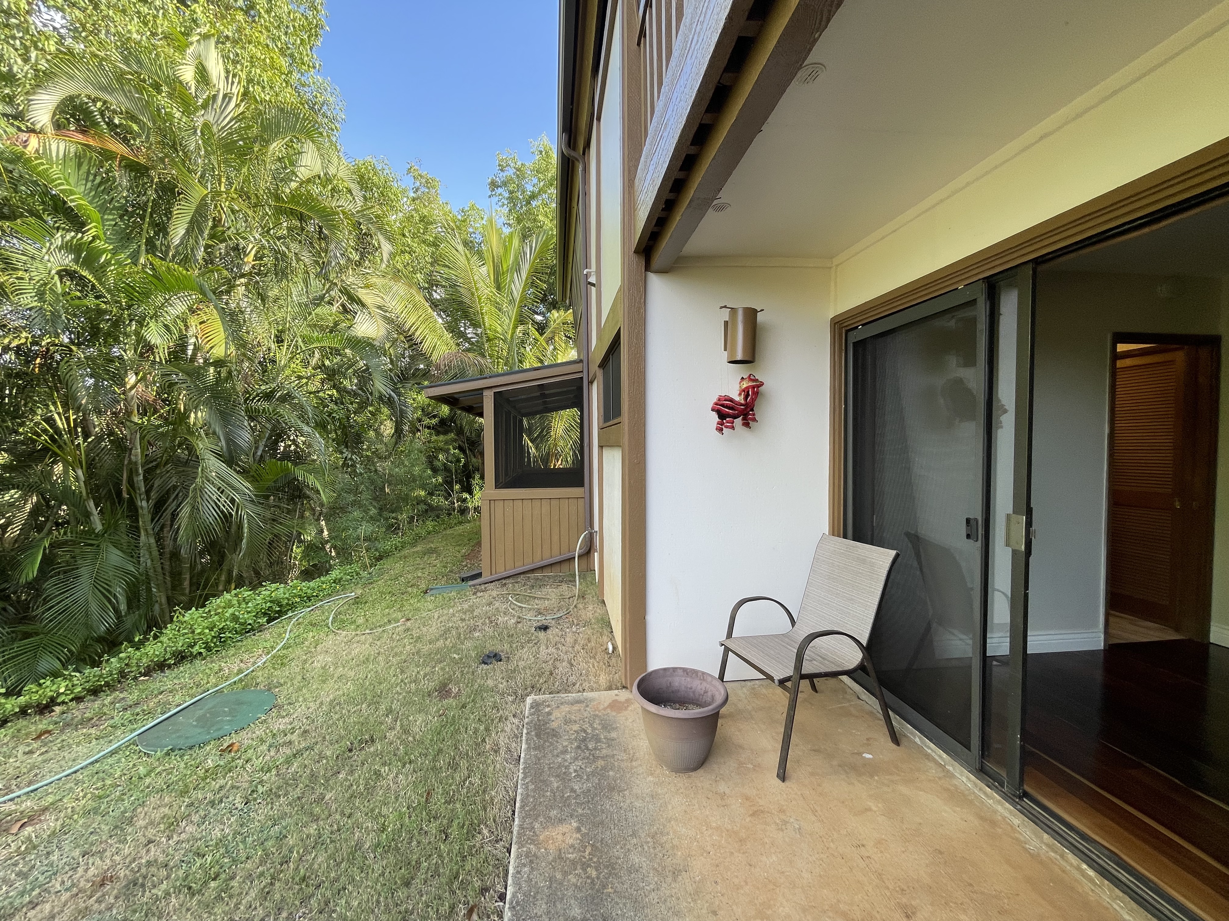 4701 Kawaihau Road, Unit L102 Kapaa, HI 96746 - Photo 10 of 10 a view of an outdoor space with lounge chair and potted plants
