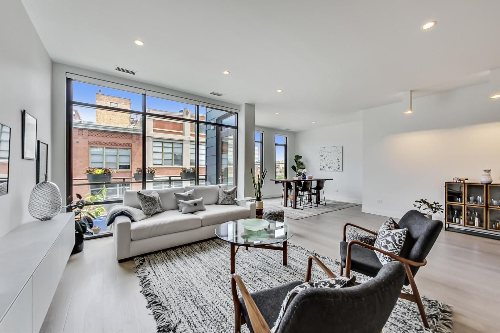 28 North Carpenter Street, Unit PHN Chicago, IL 60607 - Photo 2 of 14 a living room with furniture and a large window