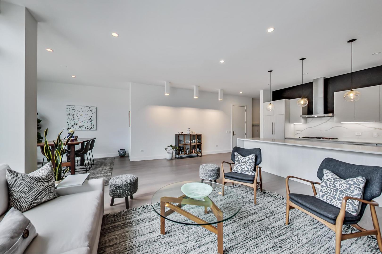 28 North Carpenter Street, Unit PHN Chicago, IL 60607 - Photo 3 of 14 a living room with furniture and kitchen view