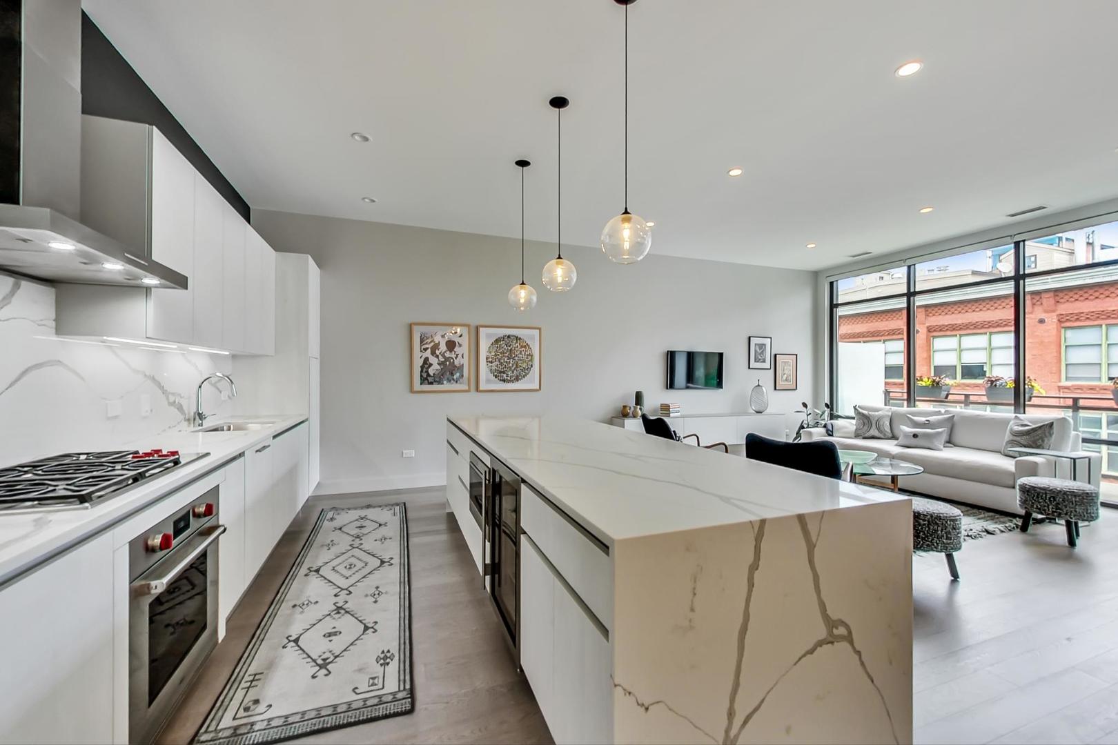 28 North Carpenter Street, Unit PHN Chicago, IL 60607 - Photo 4 of 14 a kitchen with sink stove and cabinets