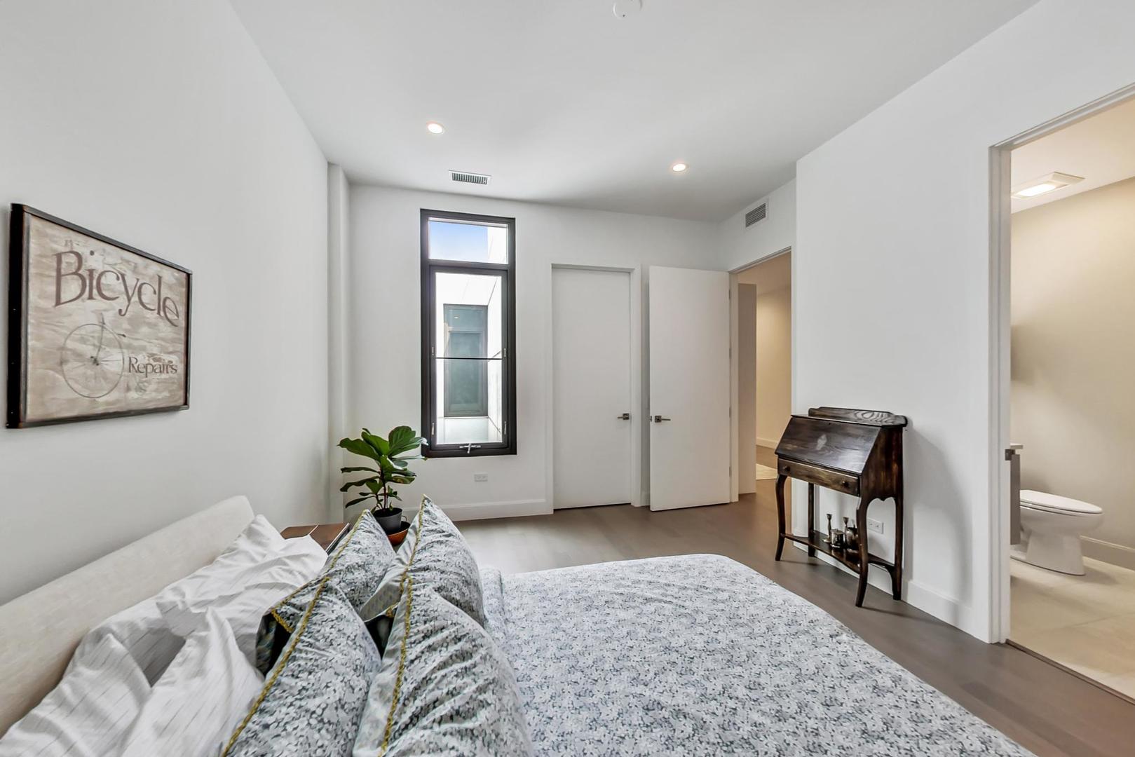 28 North Carpenter Street, Unit PHN Chicago, IL 60607 - Photo 8 of 14 a bedroom with a bed and painting on the wall