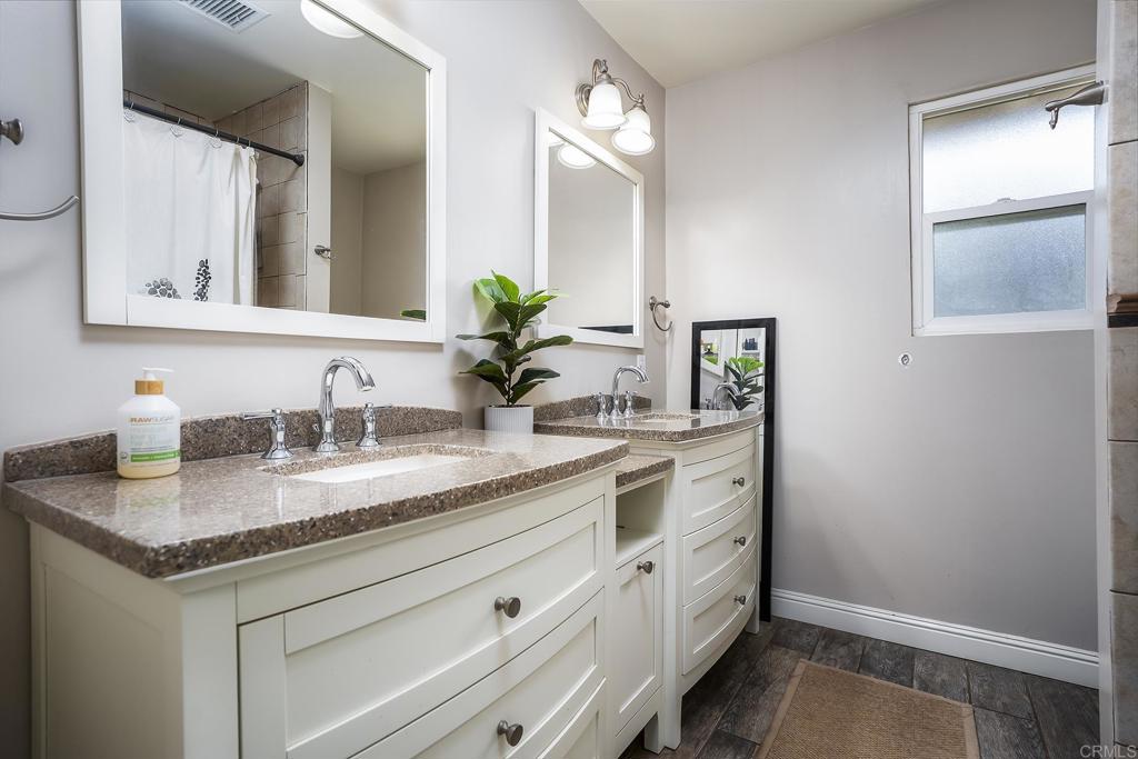 2430 Geyer Lane Alpine, CA 91901 - Photo 28 of 60 a bathroom with a granite countertop sink and a mirror