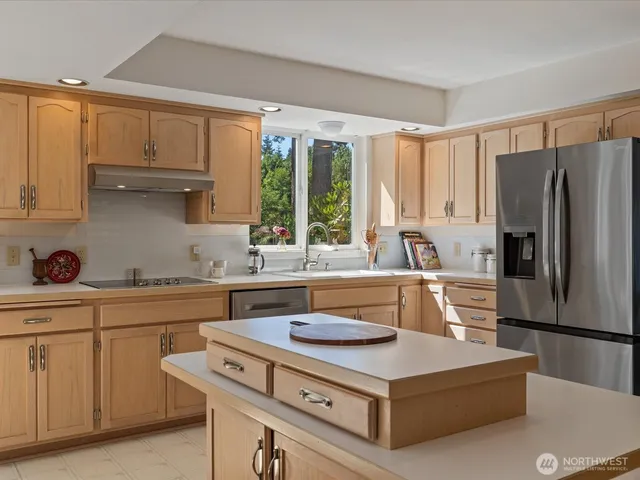 a kitchen with stainless steel appliances a sink a stove and a refrigerator