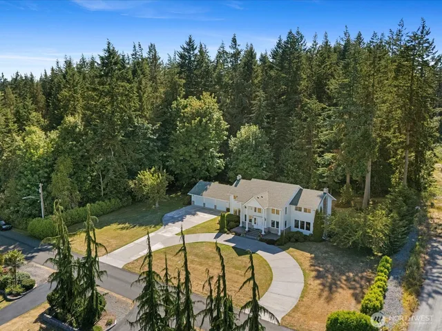a view of a swimming pool with a patio and a yard