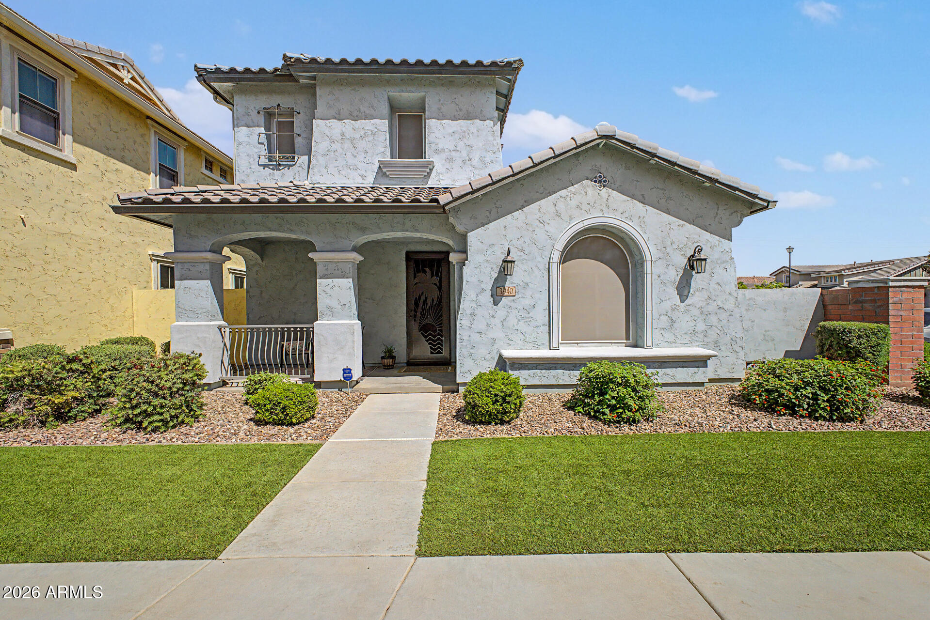 a front view of a house with a garden