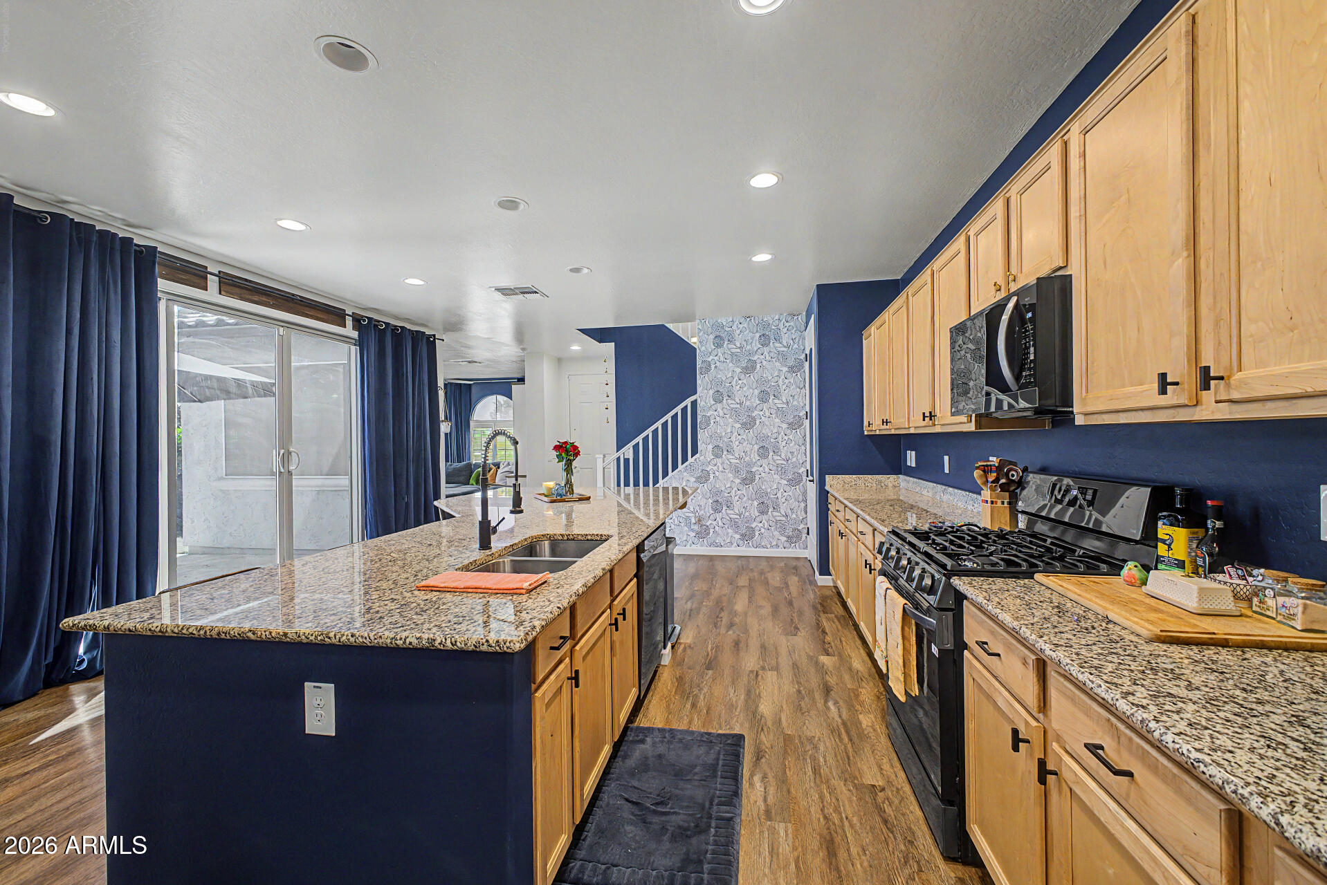 3940 East Turley Street Gilbert, AZ 85295 - Photo 16 of 50 a kitchen with granite countertop sink stove and cabinets