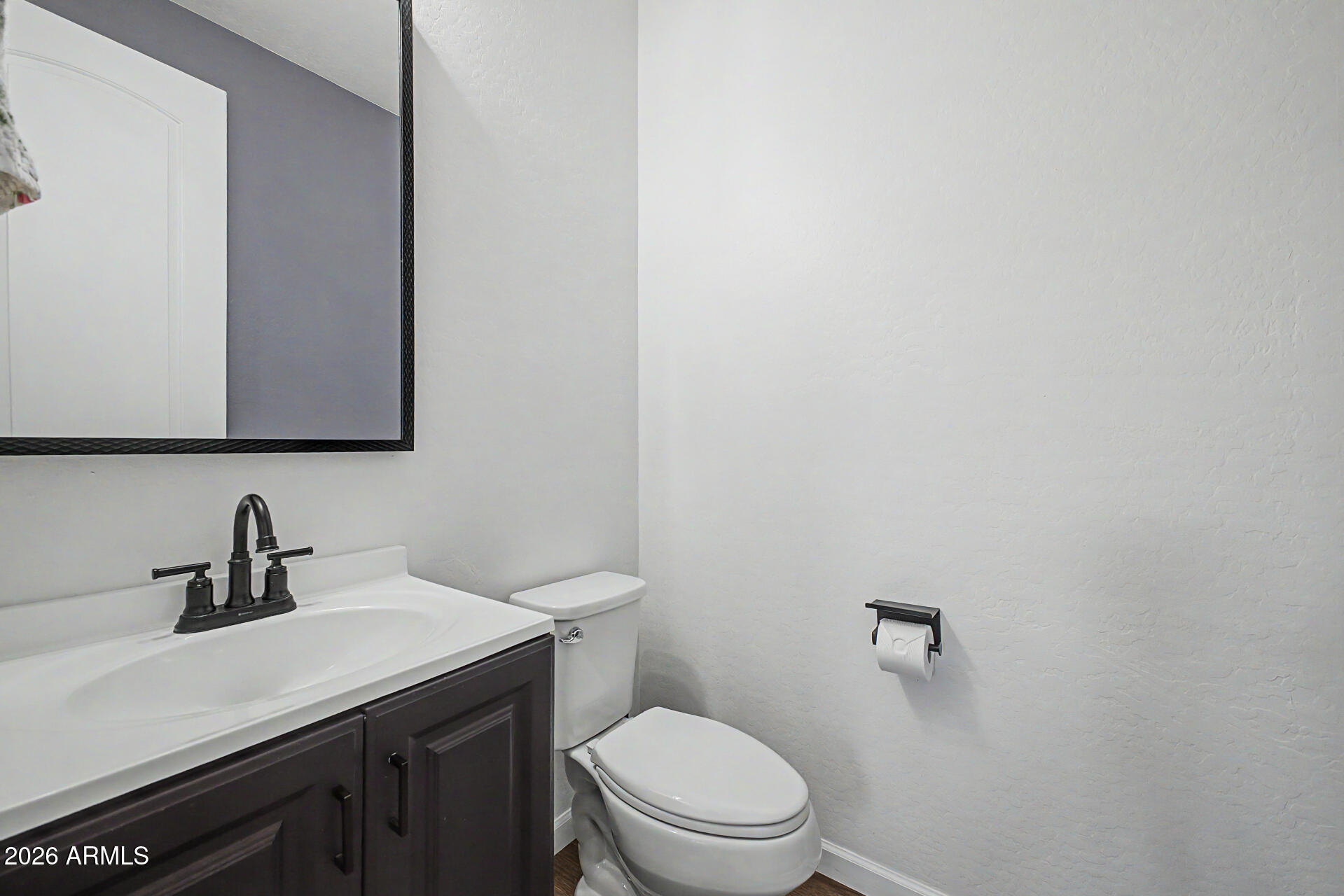3940 East Turley Street Gilbert, AZ 85295 - Photo 19 of 50 a bathroom with a toilet a sink and mirror