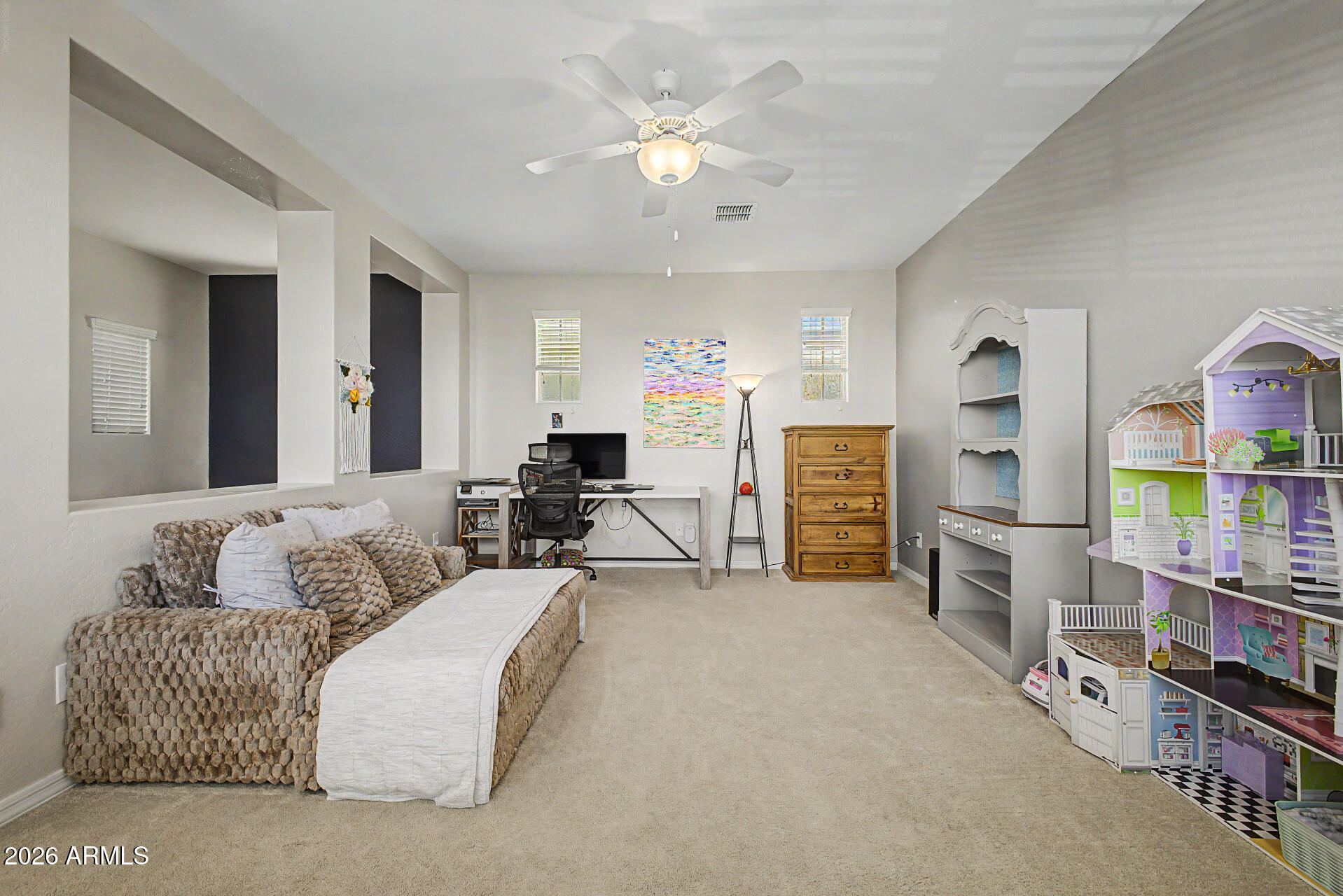 3940 East Turley Street Gilbert, AZ 85295 - Photo 29 of 50 a living room with furniture a flat screen tv and a book shelf