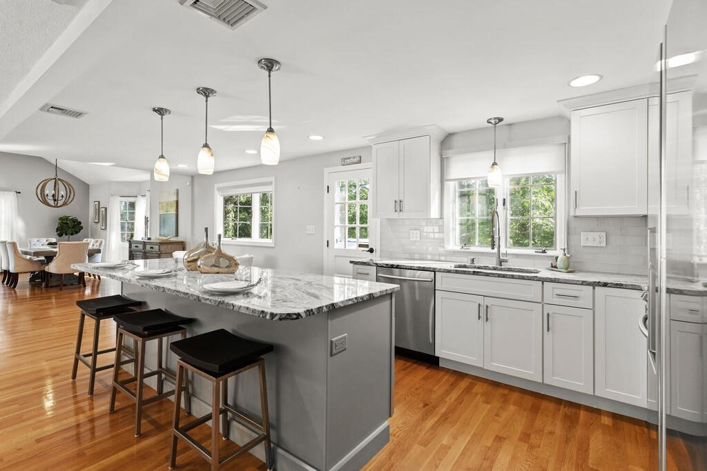33 Doncaster Circle Lynnfield, MA 01940 - Photo 12 of 31 a kitchen with center island table and chairs in it