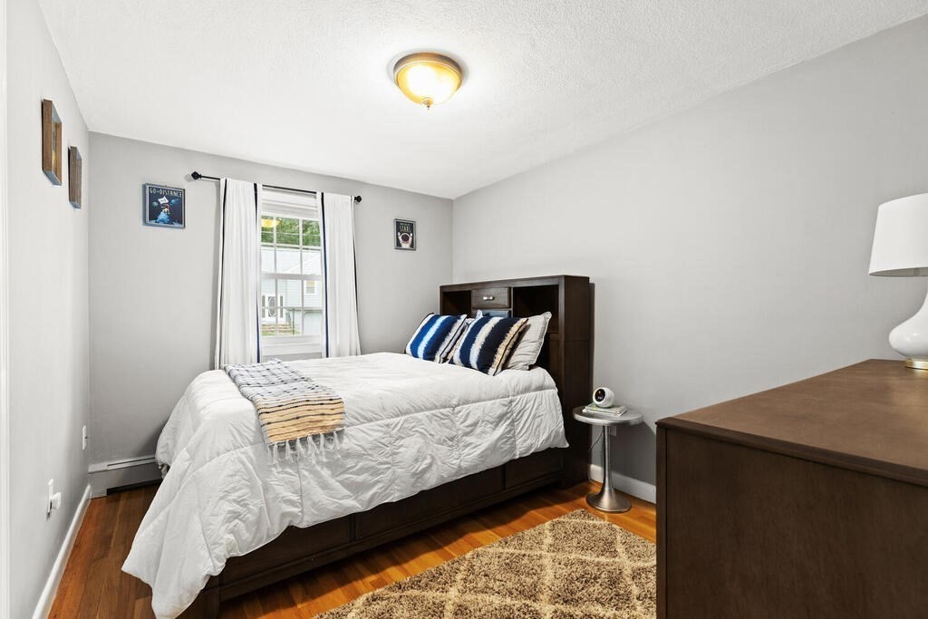 33 Doncaster Circle Lynnfield, MA 01940 - Photo 16 of 31 a bed sitting in a bedroom next to a window