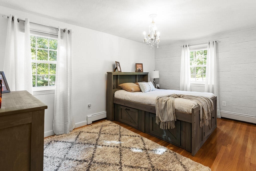 33 Doncaster Circle Lynnfield, MA 01940 - Photo 18 of 31 a bedroom with a bed and a chandelier