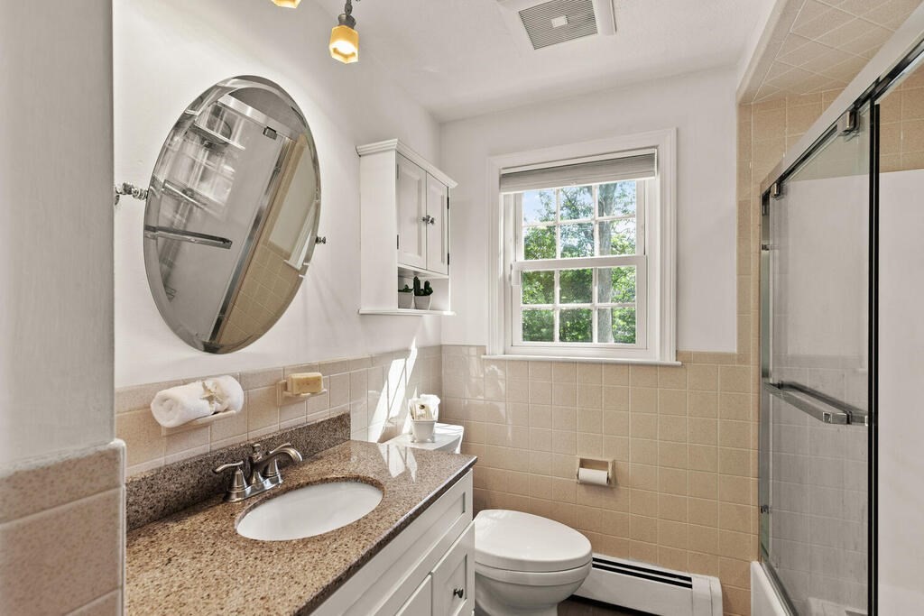 33 Doncaster Circle Lynnfield, MA 01940 - Photo 19 of 31 a bathroom with a toilet a sink and mirror