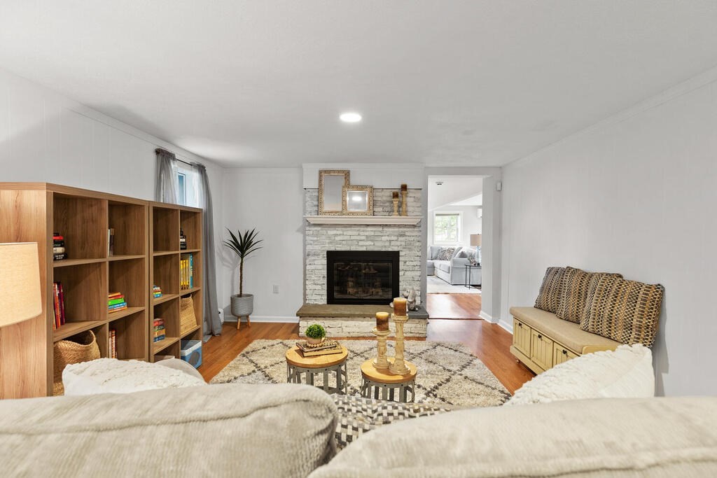 33 Doncaster Circle Lynnfield, MA 01940 - Photo 21 of 31 a bedroom with a bed a couch and a fireplace