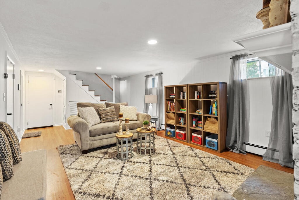 33 Doncaster Circle Lynnfield, MA 01940 - Photo 22 of 31 a living room with furniture and a book shelf