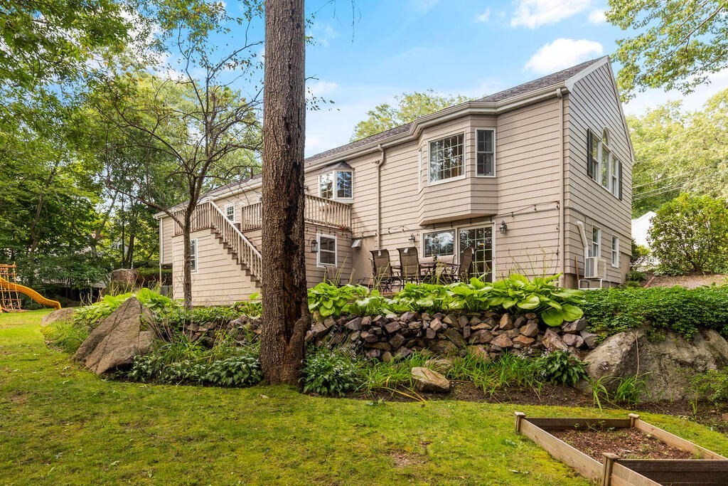 33 Doncaster Circle Lynnfield, MA 01940 - Photo 29 of 31 a front view of a house with a yard and potted plants
