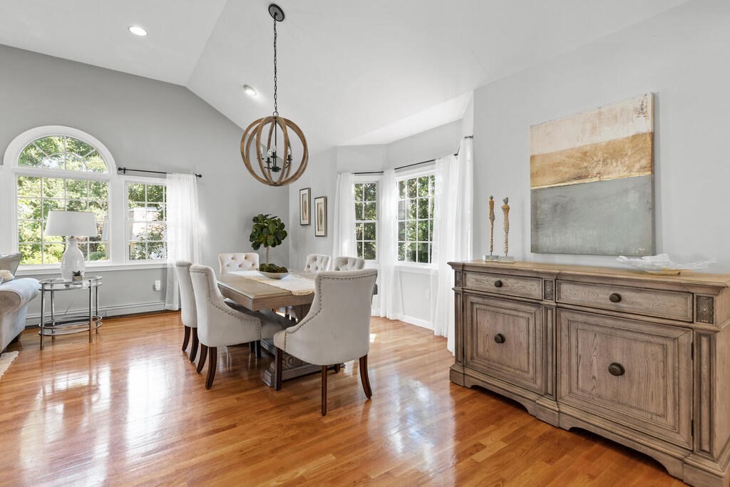 33 Doncaster Circle Lynnfield, MA 01940 - Photo 8 of 31 a dining room with wooden floor a glass table and chairs