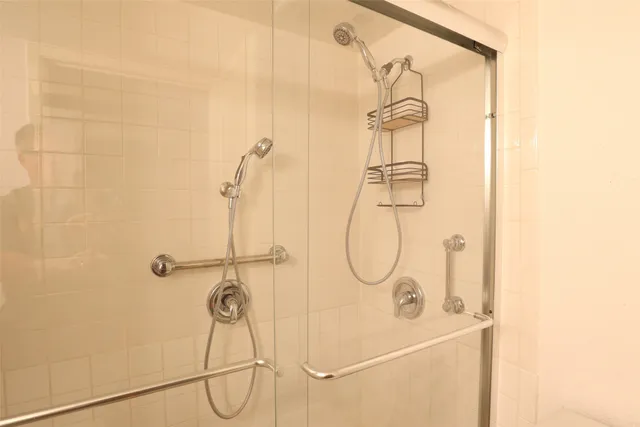 an empty room with windows and ceiling fan