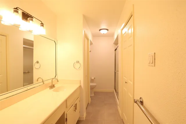 a view of a hallway with wooden floor and a living room