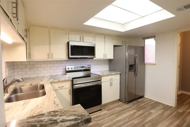 a kitchen with a refrigerator stove and sink