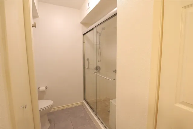 a view of a hallway with wooden floor and door