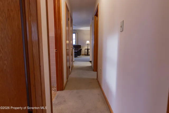 an empty room with wooden floor and mirror