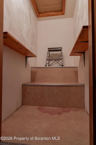 a kitchen with white cabinets a sink and dishwasher