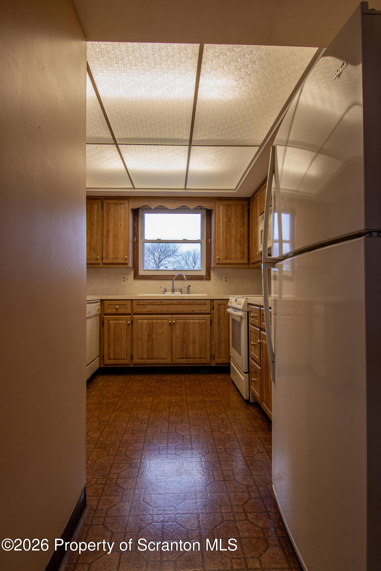 1215 Mine Street Old Forge, PA 18518 - Photo 16 of 34 a view of a kitchen with a fridge and wooden floor
