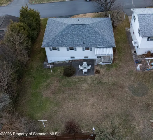 a white house with a yard and sitting space