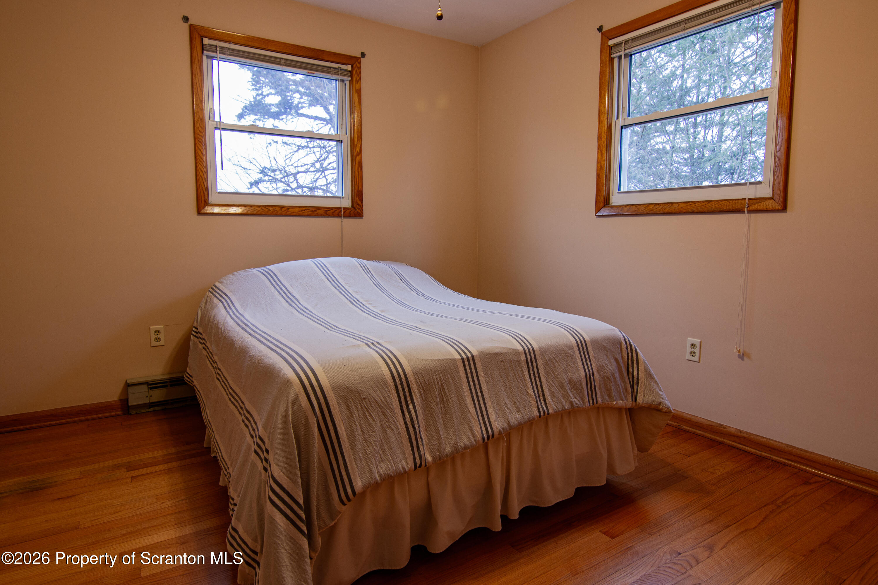 1215 Mine Street Old Forge, PA 18518 - Photo 10 of 34 a bed sitting in a bedroom next to a window