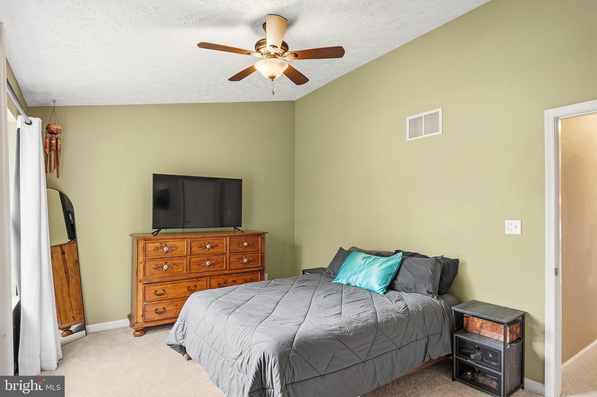757 209th Street Pasadena, MD 21122 - Photo 12 of 32 a bedroom with a bed and a flat screen tv