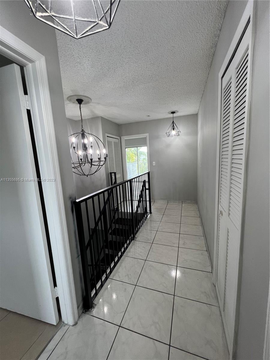14661 Southwest 99th Street Miami, FL 33186 - Photo 11 of 14 a view of a hallway view with staircase