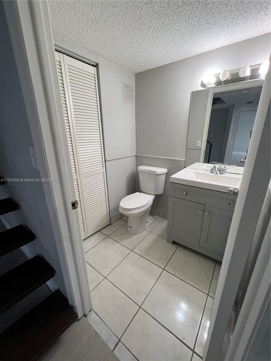 14661 Southwest 99th Street Miami, FL 33186 - Photo 13 of 14 a bathroom with a sink a toilet and mirror
