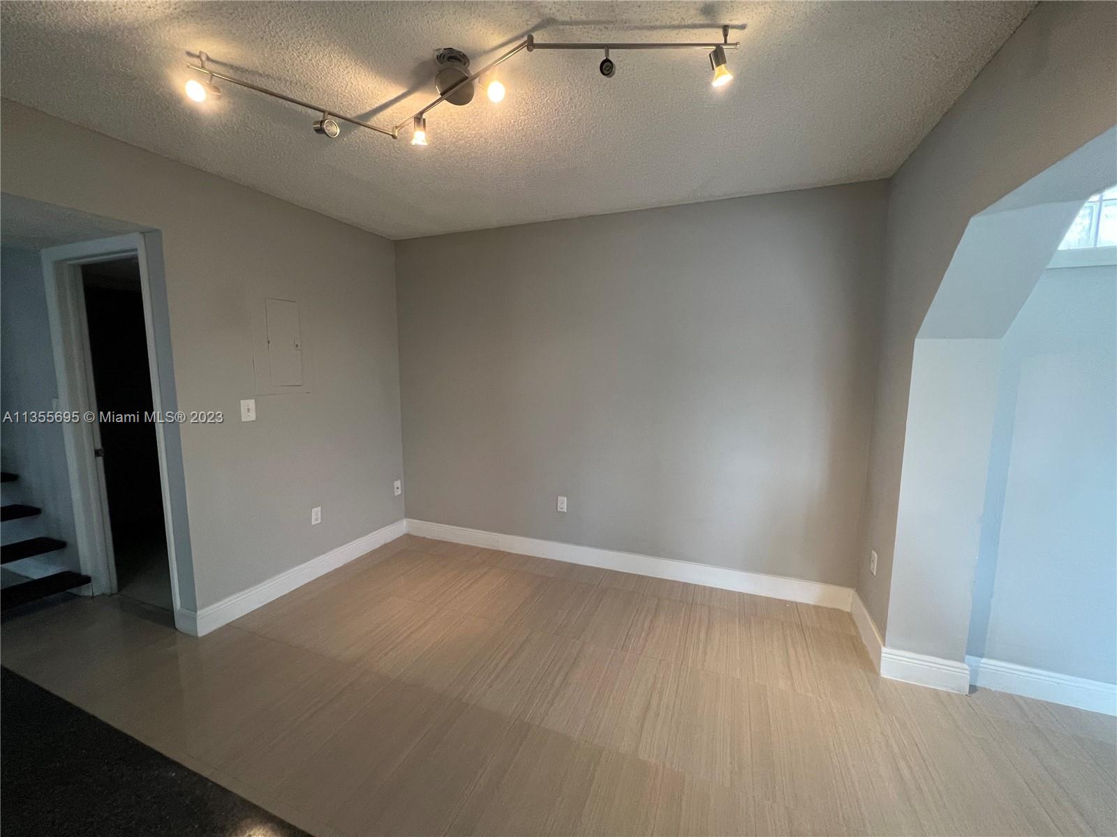 14661 Southwest 99th Street Miami, FL 33186 - Photo 14 of 14 an empty room with wooden floor and windows