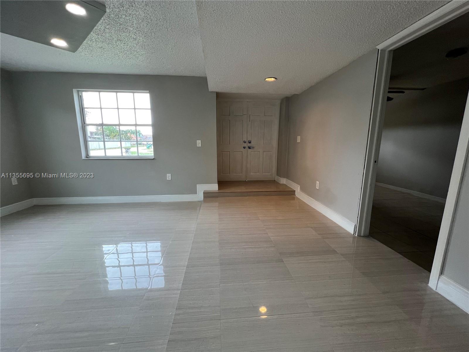 14661 Southwest 99th Street Miami, FL 33186 - Photo 3 of 14 a view of an empty room with a window