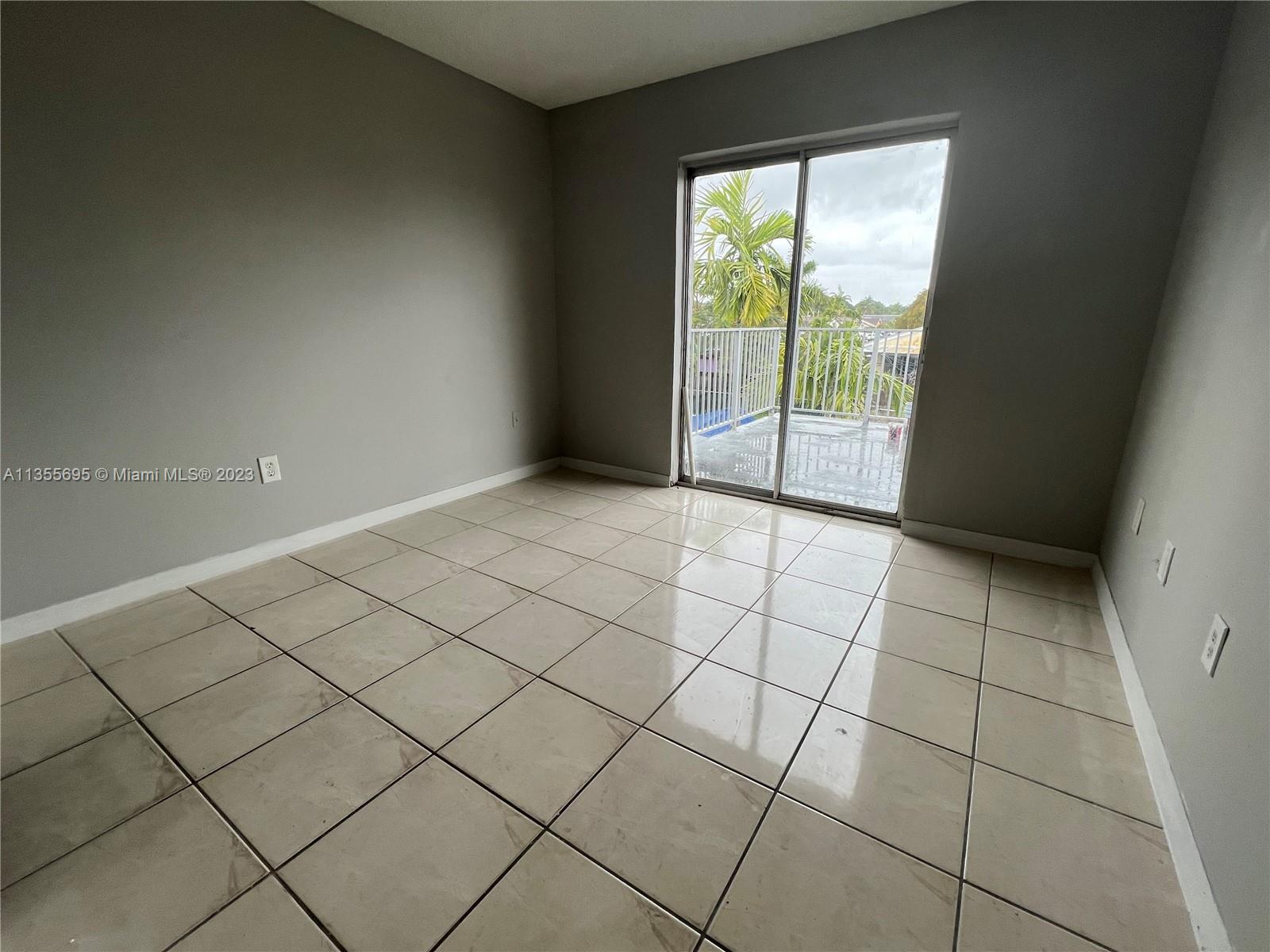 14661 Southwest 99th Street Miami, FL 33186 - Photo 5 of 14 a view of an empty room and a window