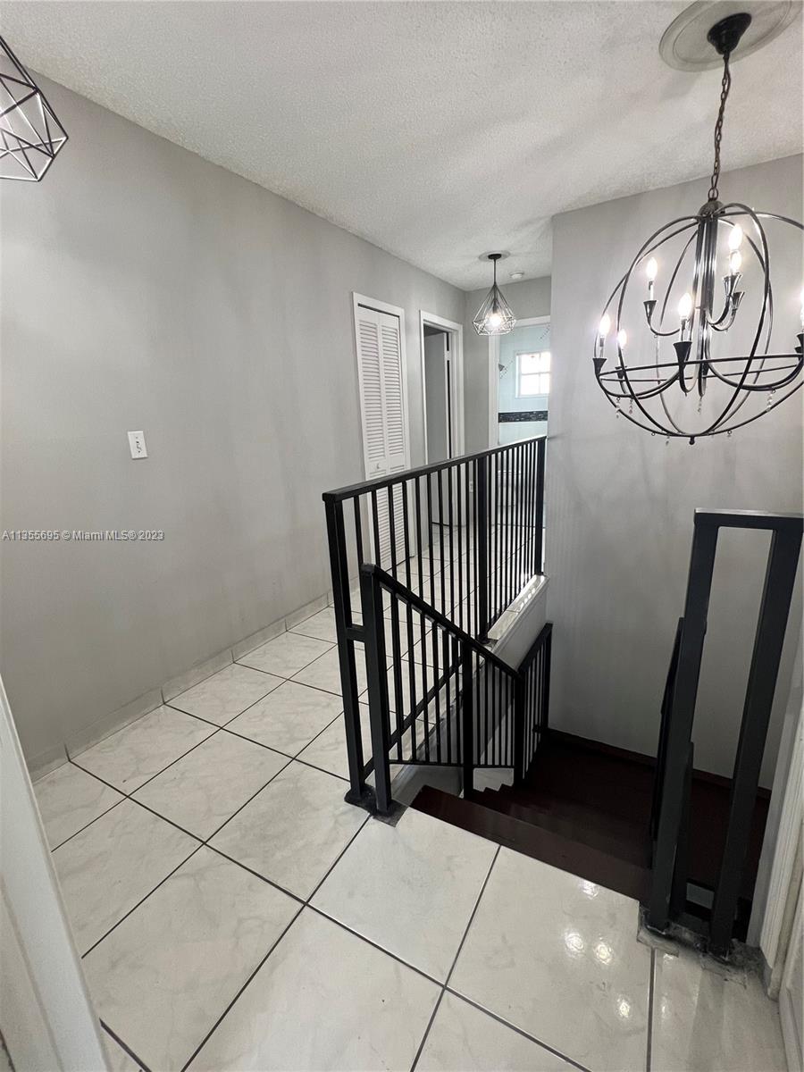 14661 Southwest 99th Street Miami, FL 33186 - Photo 6 of 14 a view of a hallway with window