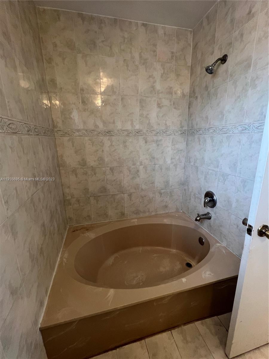 14661 Southwest 99th Street Miami, FL 33186 - Photo 9 of 14 a bathroom with a bathtub