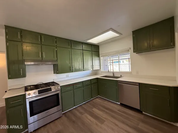 a kitchen with sink a microwave and cabinets