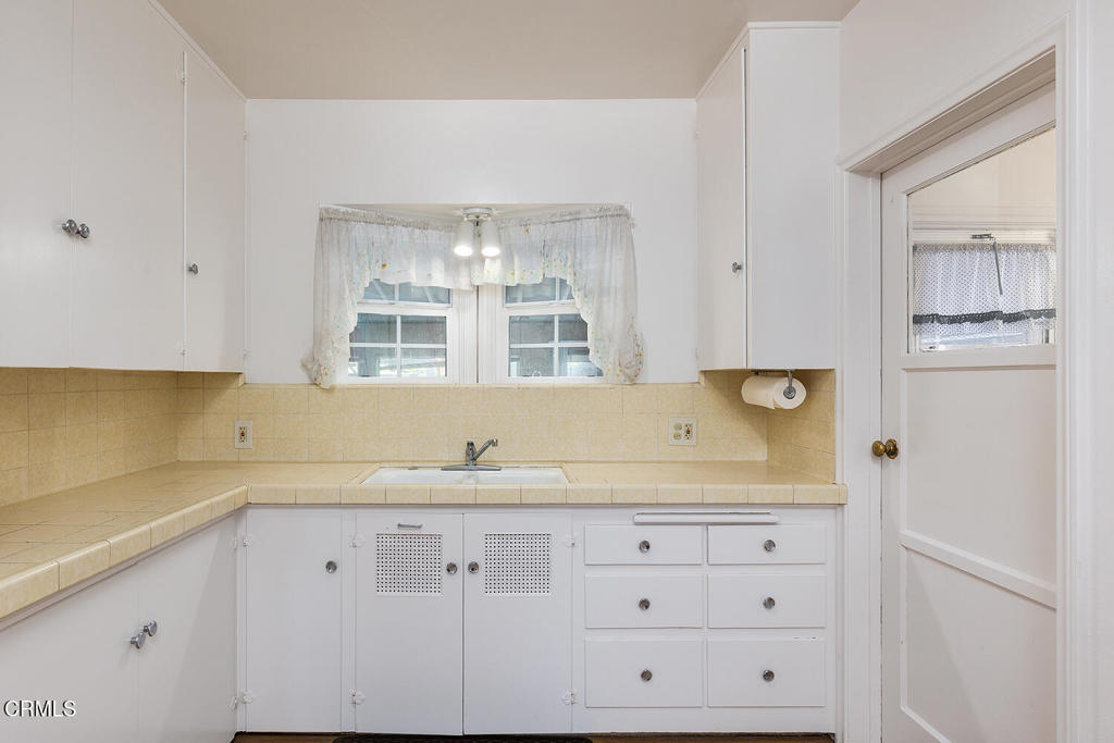 1012 South 2nd Street Alhambra, CA 91801 - Photo 11 of 25 a kitchen with granite countertop white cabinets and stainless steel appliances