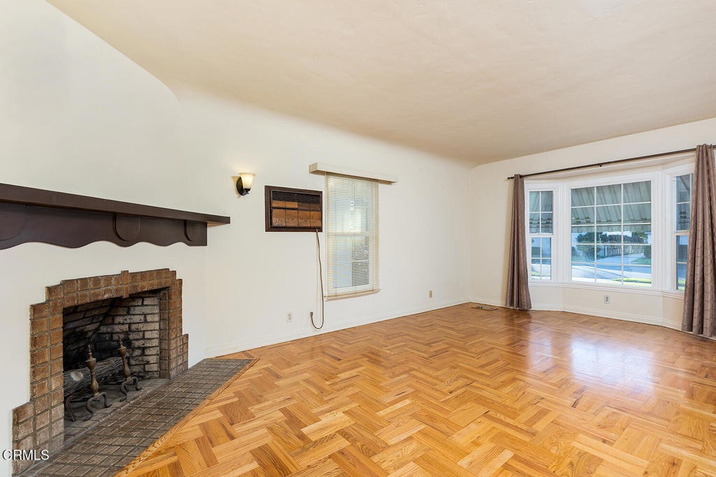 1012 South 2nd Street Alhambra, CA 91801 - Photo 6 of 25 a view of a livingroom with wooden floor and a fireplace