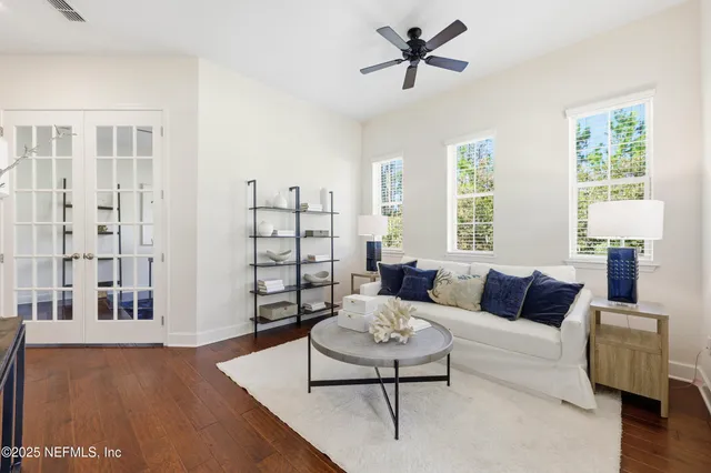 a living room with furniture and wooden floor