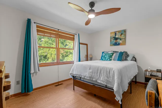 a bed sitting in a bedroom next to a window