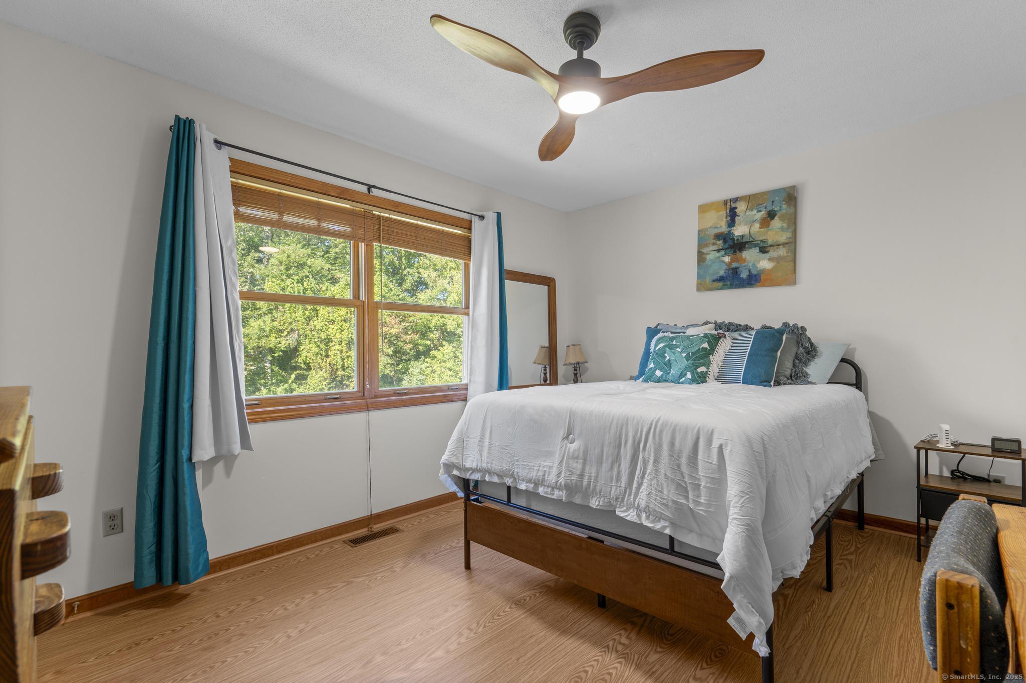 a bed sitting in a bedroom next to a window